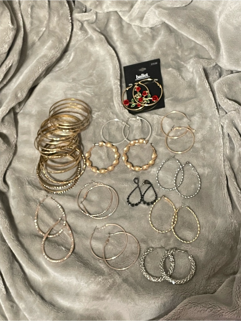 Lot of hoop earrings and bangle bracelets